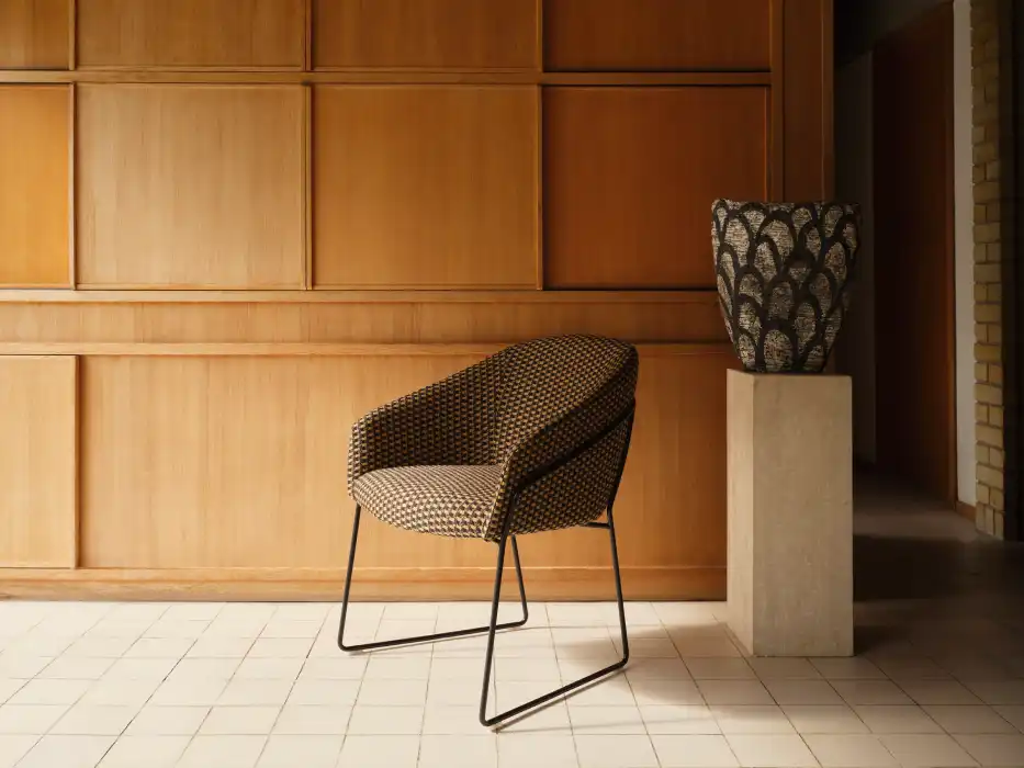 Lounge chair with black sled wire frame and chequered upholstery