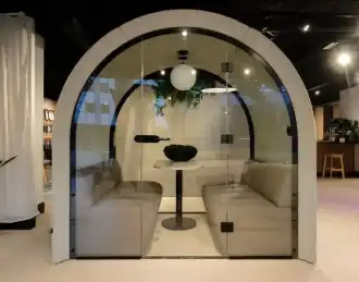 Arch-shaped office pod with sofas and meeting table
