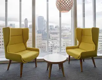 Single seat high-back winged acoustic armchair for focused office work